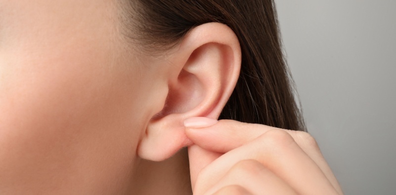 A woman touching her earlobe