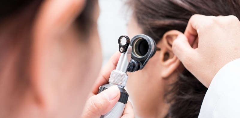 Audiologist carrying out a hearing assessment